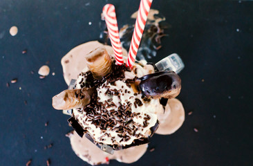 Chocolate milkshake dessert shows ice cream melting under drink.  Delicious looking sweet treat for...