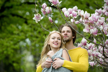 spring. happy couple in love in spring magnolia flowers © Volodymyr