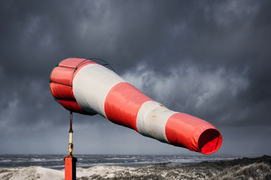 Windsock, stormy sea and dunes