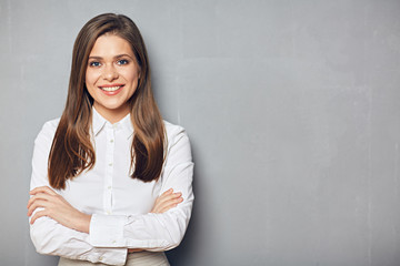 Smiling businesswoman with folded hand.