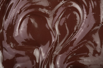 Melted chocolate swirl as a background closeup