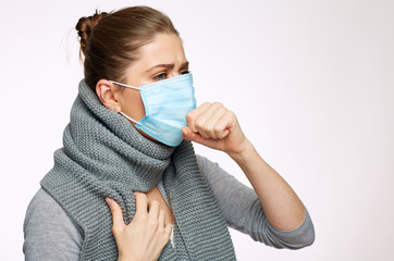 Coughing woman wearing medical mask.