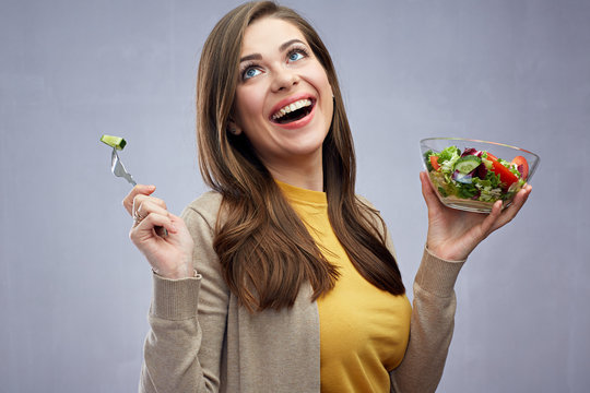 Happy woman eating healthy salad food.