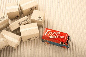 Free shipping van, vintage toy truck with cardboard boxes. Delivery concept.