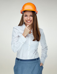 Portrait of young confident businesswoman wearing builder helmet