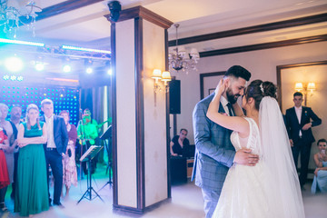 First dance the bride and groom in the smoke. brides wedding party in the elegant restaurant with a...