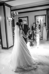 First dance the bride and groom in the smoke. brides wedding party in the elegant restaurant with a...