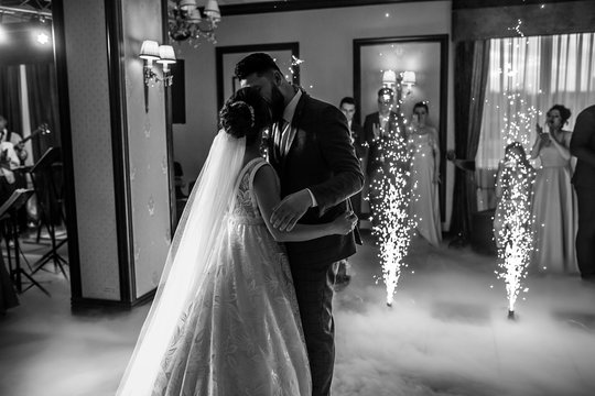 First dance the bride and groom in the smoke. brides wedding party in the elegant restaurant with a wonderful light and atmosphere