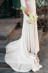 Fototapeta na wymiar Bride holding beautiful white wedding flowers bouquet
