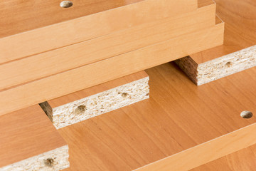 Wooden boards planked on the floor. Furniture material made of chipboard. Home assembling furniture.