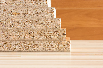 Wooden boards planked on the floor. Furniture material made of chipboard. Home assembling furniture.