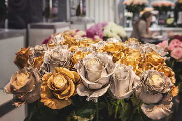 Bouquet of roses metallic color. Chameleon flowers with gold and silver petals on the edges.