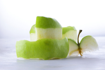 Green peeled apple, apple skin, fruit, healthy food, yak on a light background for the designer, vegetarian food, apple pop art, minimalism, isolated