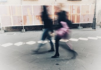 blurry people walking in the city center