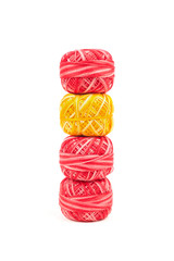 Four sewing threads on white background. Red and yellow thread