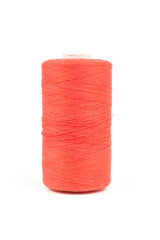 Orange spool of thread on white background