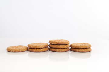 piles of round cookies on studio white background