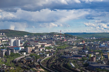 Fototapeta na wymiar The urban landscape of the Murmansk Soviet architecture and the bright foliage of summer.
