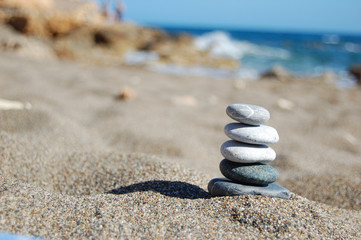 Balance of stones on the beach, sunny day