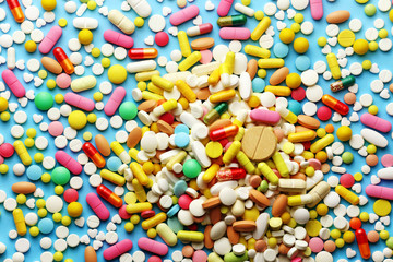 Colorful pills on a blue