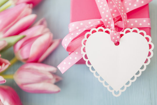 Pink Gift with Heart Tag and fresh Tulips for Mother's Day, Birthday and Love