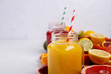 Juices Fresh Orange and Citrus on a White Background.Healthy Beverage.Food or Healthy diet concept.Mixed Colorful Tropical Background.Copy space for Text. selective focus