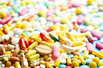 Colorful pills on a blue background