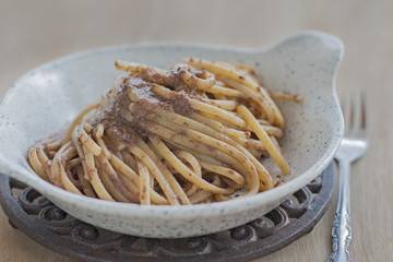 Close up of a dish of linguine with taggiasca olives patè.