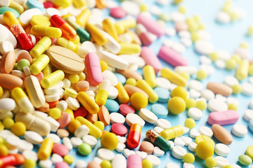 Colorful pills on a blue background