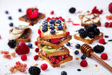  Sandwiches Set sweet with cream-cheese and fresh berries and fruit over pine Nut,a white background . Concept of Healthy Food.Breakfast snack.selective focus.