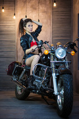 Obraz na płótnie Canvas beautiful young girl on a motorcycle