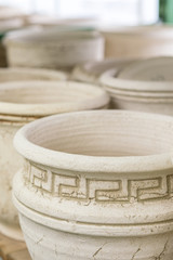 Large empty clay pots on the shelf