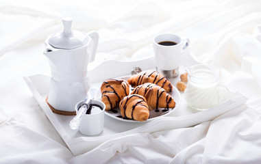  Breakfast Continental  with Fresh  Croissants on a  white Background Breakfast in bed. Coffee with Milk and Delicious Baking with  with Chocolate Topping