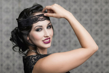 brunette in black dress in the style of decadence