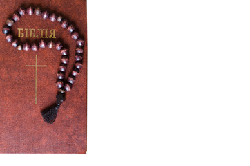 Isolated prayer rope. Wooden prayer rope with bible isolated on white background