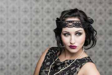 brunette in black dress in the style of decadence