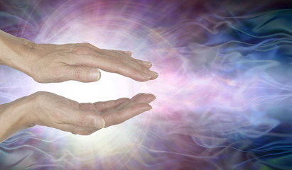 Fototapeta na wymiar Channelling Vortex healing energy - female hands held parallel with a white vortex energy formation and pink blue ethereal energy field background 