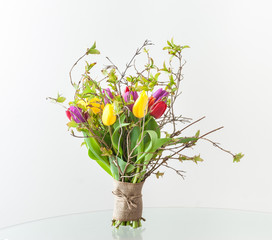 Spring bouquet of tulips with young twigs
