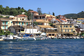 Fototapeta na wymiar Quay of the village of Kassiopi is a tourist village in the north of the island of Corfu
