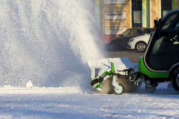 street cleaning the city from snow with the help of special machinery