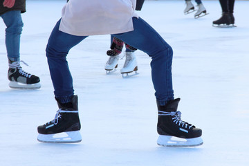 Obraz premium feet on the skates of a person rolling on the ice rink