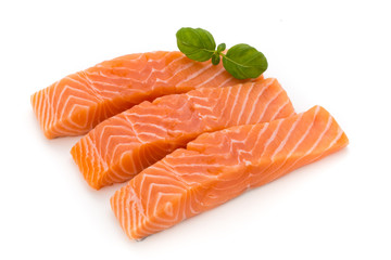Fresh salmon fillet with basil on the white background.