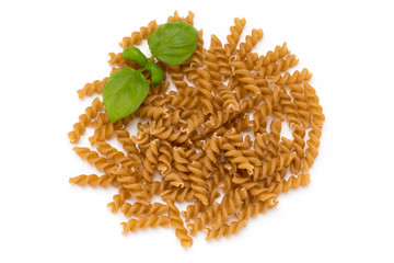 Uncooked wholemeal pasta isolated white background.