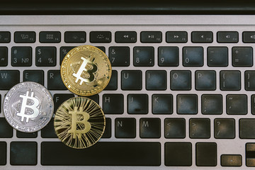golden bitcoins on notebook keyboard
