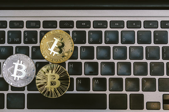 golden bitcoins on notebook keyboard