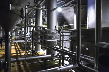 Modern beer factory, brewery concept. Steel tanks for beer production. Industrial background