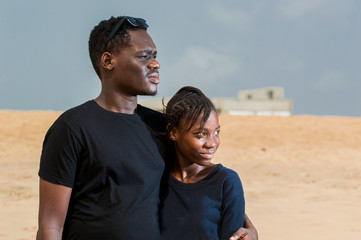 two young people standing at the beach