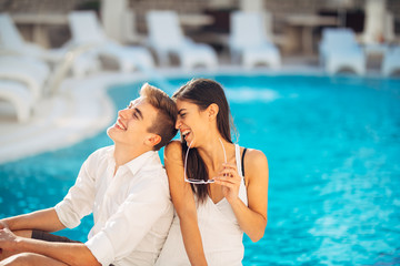 Cheerful happy couple enjoying spa vacation in luxurious summer resort.Honeymoon trip.Anniversary  celebration.Boyfriend and girlfriend having fun.Emotional connection.Engagement.Newlyweds