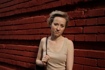 woman on the background of red brick wall