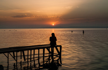 Girl watching sunset on the balaton